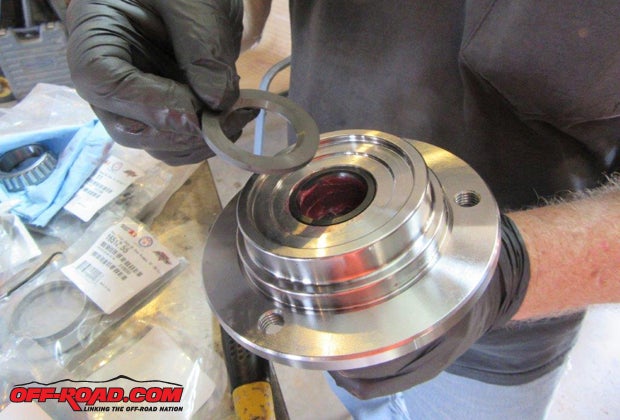 The bearing should be installed in the back side of the spindle with the proper tool. Make sure the bearing is completely seated in the spindle. Now install dust seal; the open side of the seal goes inward toward the bearing.
