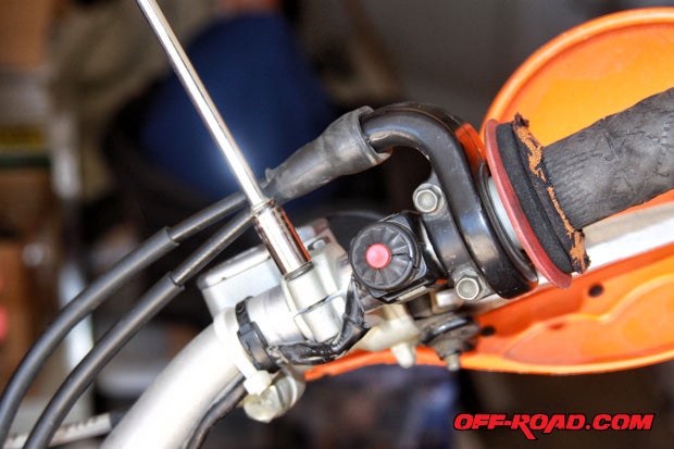 Loosen the brake lever and throttle assembly to allow for adjustment. You may need to cut zip-ties to allow some cable wiring slack when positioning U-Clamps.