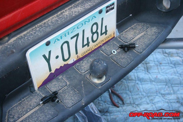 I used a separate Schrader valve for each air shock, which were mounted to either side of the license plate.